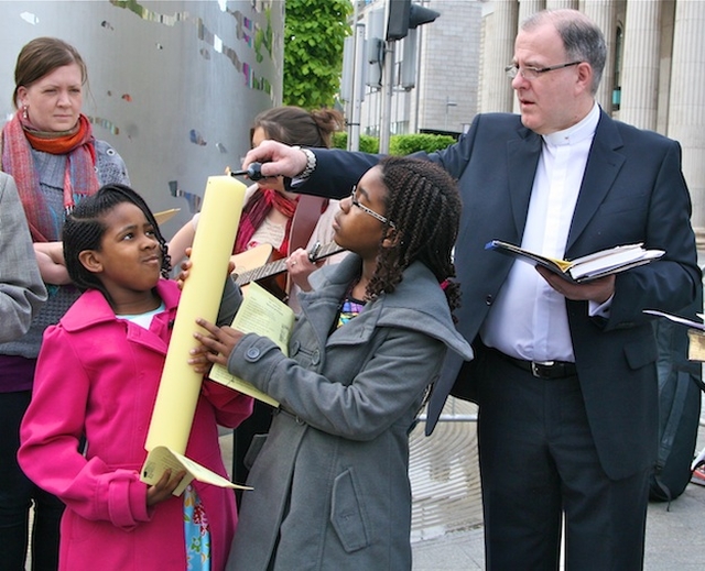 Fr Damien O'Reilly, Administrator of St Mary's Pro Cathedral, lighting the candle at the Ecumenical Easter Sunday Service at the Spire, O' Connell St, Dublin 1.