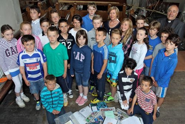 Pupils from Blessington No 1 School have gathered items and information about themselves and life in 2014 to create a time capsule which is to be buried under the new floor of St Mary’s Church, Blessington. Some of the pupils are pictured with their Principal, Mrs Lilian Murphy and the Rector, the Revd Leonard Ruddock, in the church. 