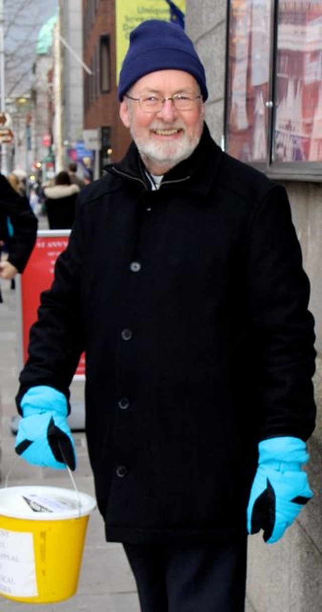 Curate of St Ann’s, the Revd Martin O’Connor, collecting outside the church at the launch of the 2013 Black Santa Sit Out which continues until Christmas Eve. 