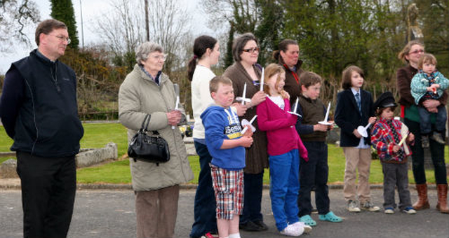 Rector of Inch, Revd Nigel Sherwood, and members of the congregation gather outside the church for their children’s Easter Vigil.