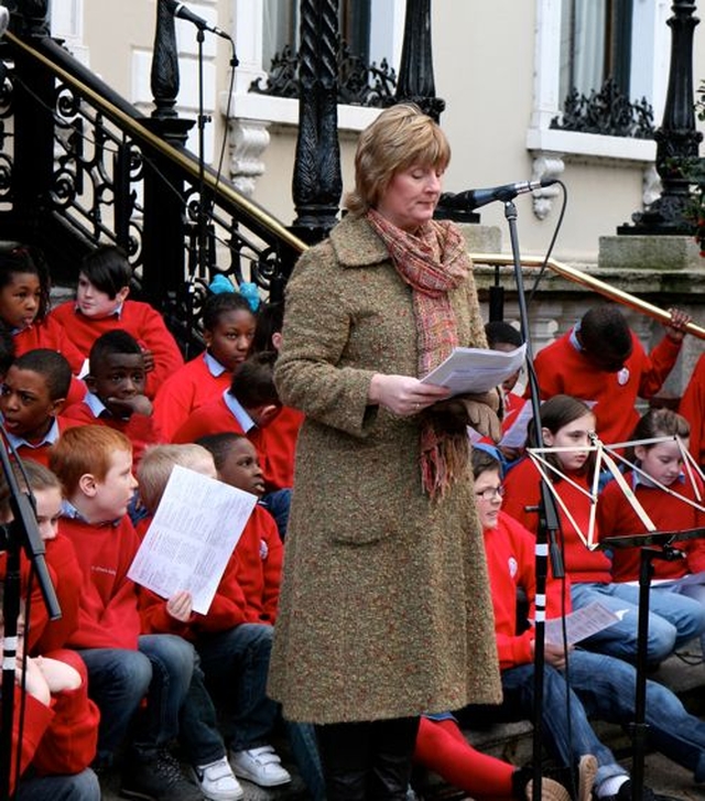 Diocesan Mothers’ Union President, Joy Gordon, reads at the Community Carol Singing outside the Mansion House on Saturday December 15.
