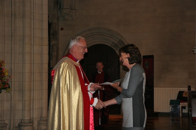 Archbishop John Neill presenting Heather Waugh with a certificate for completing the Archbishop's Certificate Course in Theology. 