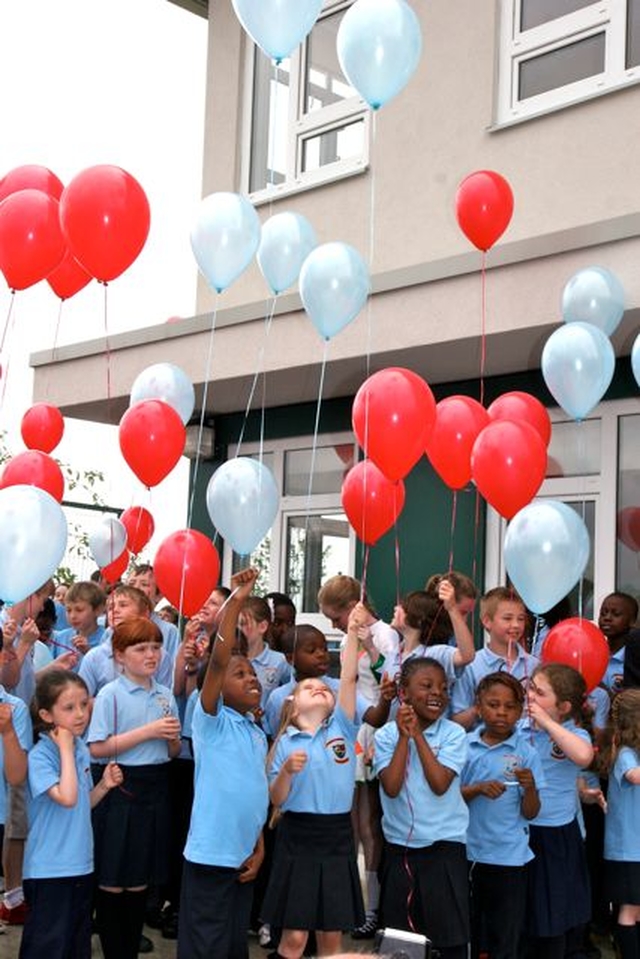 Pupils of Athy Model School prepare to release their balloons – each representing a dream for the school – at the official opening and blessing of their new school building. 