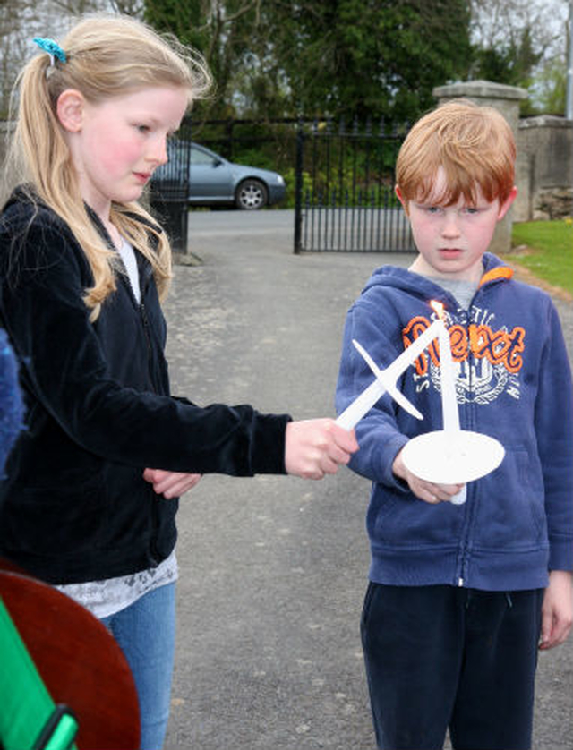 Young parishioners light each others’ candles at the first children’s Easter Vigil at Inch Church.