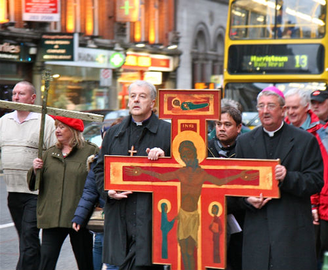 With Archbishops Michael Jackson and Diarmuid Martin at the front, the procession of the cross makes its way down Dame Street amidst heavy city centre traffic.