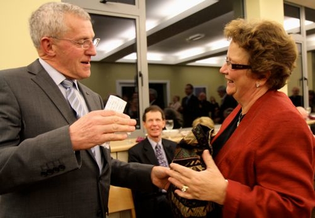 Former Dean of Down, John Dinnen, makes a presentation to CITI staff member, Daphne Metcalfe, at the celebrations marking the 50th anniversary of the move to Braemor Park yesterday, February 17.