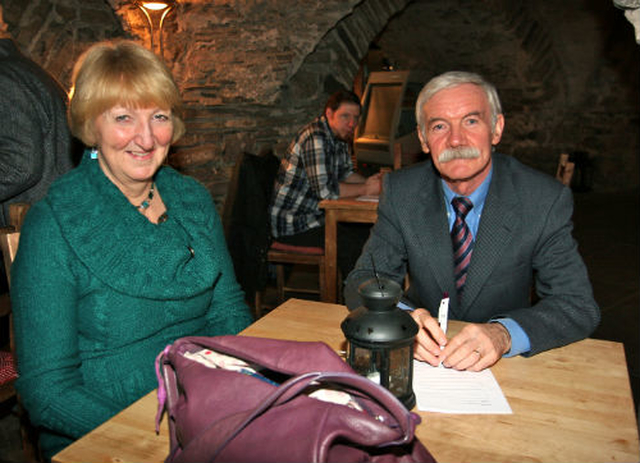 Celia Dunne and Ted Shine prepare their strategy before the Crypt table quiz in Christ Church Cathedral. 