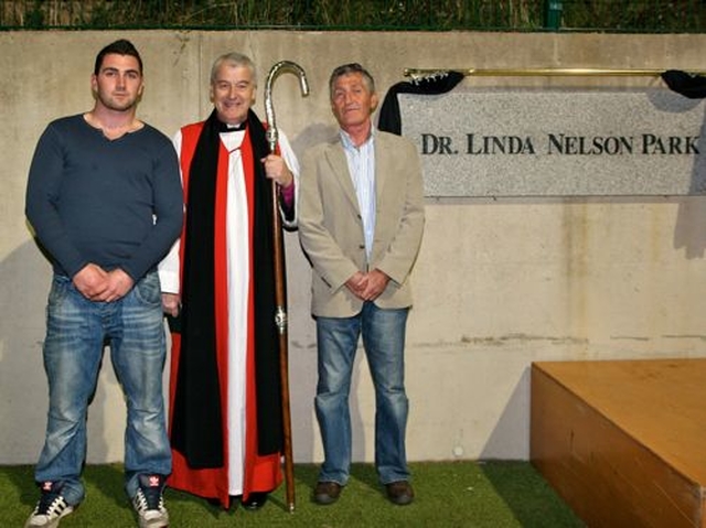 Simon and John Nelson, son and husband of the late Dr Linda Nelson, with Archbishop Michael Jackson following the dedication of the new hockey pitch at East Glendalough School.