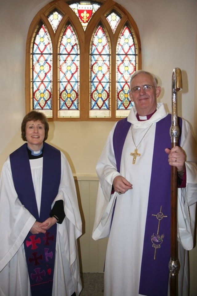 The Revd Adrienne Galligan, Rector of Crumlin and Chapelizod and the Archbishop of Dublin, the Most Revd Dr John Neill in front of one of two stained glass windows in St Laurence's Church, Chapelizod recently refurbished and re-dedicated. 