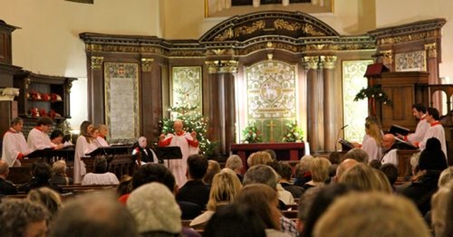 St Ann’s Musical Director, Charles Marshall, conducts the choir during the annual Civic Carol Service in the church. 