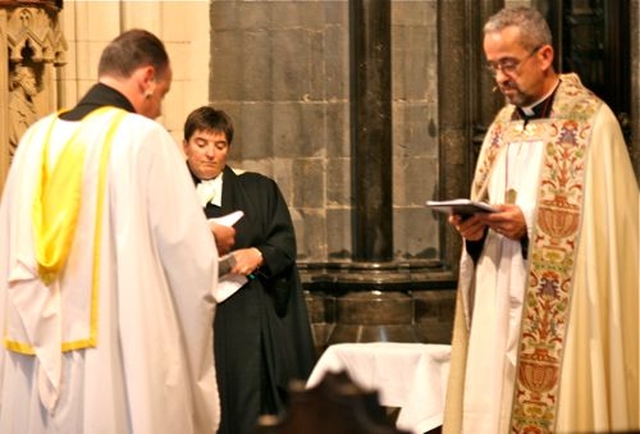 The Revd Roy Byrne is installed as the Twelfth Canon of Christ Church Cathedral by Dean Dermot Dunne with the Chapter Clerk of the cathedral, Revd Gillian Wharton. 