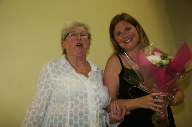 Dilys, wife of the Revd Rob Jones, newly instituted Vicar of Rathmines and Harolds' Cross receives flowers from Isobel Henderson, Churchwarden at the reception following Rob's Institution.