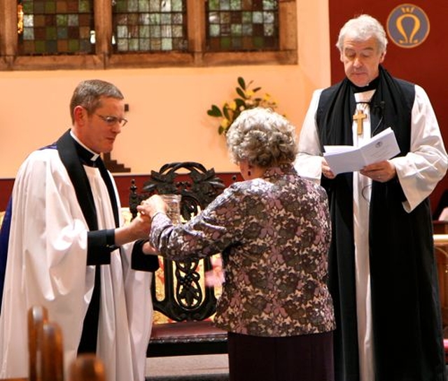 Members of the parish of St Catherine and St James with St Audoen present Canon Mark Gardner with symbols of the teaching, pastoral and sacramental ministry of an incumbent at his institution as rector of the new union of parishes. 