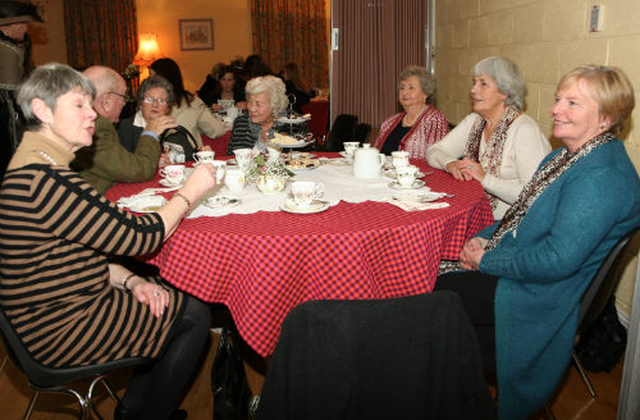 A group of people enjoying themselves at Rathmichael’s Edwardian tea party to celebrate Nollag na mBan.