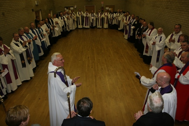 The assembled clergy congratulate the Revd David Gillespie at his institution as Vicar of St Ann's with St Mark's and St Stephen's.