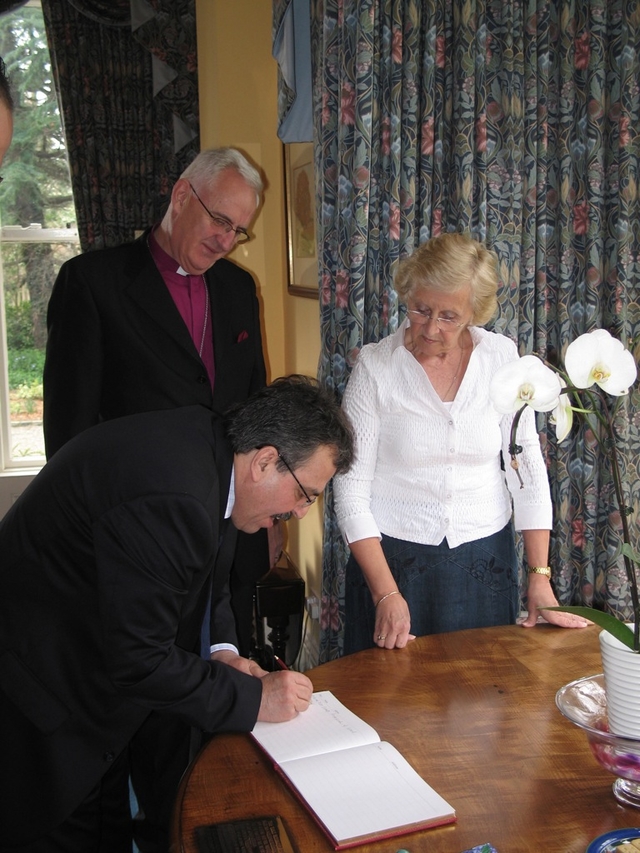 The Archbishop of Dublin, the Most Revd Dr John Neill and his wife Betty watch as the Ambassador of Palestine HE Dr Hikmat Ajjuri signs the visitors’ book during his visit to the See House in Dublin recently.