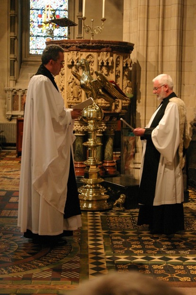 The Chancellor of Christ Church Cathedral, the Revd Canon Neil McEndoo reads the certificate of nomination of the new Dean, the Very Revd Dermot Dunne (left) during the new Dean's installation.