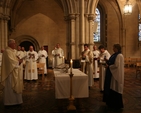 A lay reader (Barbara O'Callaghan), a Deacon (the Revd David McDonnell) and a Priest (the Revd Aisling Shine) present oil for blessing at Chrism Eucharist in Christ Church Cathedral.