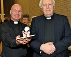 Black Santas Canon David Gillespie and Dean Houston McKelvey with a mini Black Santa baked specially for the distribution of funds service at St Ann’s, Dawson Street. 
