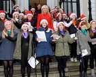 RTE’s Miriam O’Callaghan is surrounded by the choir, Teen–Spirit, following the annual ecumenical carol singing on the steps of the Mansion House which took place yesterday, Saturday December 14. 