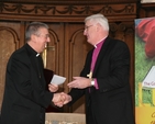 The Archbishop of Dublin, the Most Revd Dr John Neill (right) presents a cheque to the Most Revd Diarmiud Martin towards the costs of the Gospel of Luke which is jointly produced by the two Dioceses. The Gospel of Luke was launched in Trinity College Chapel.