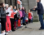Ian Packham conducts the choir of the Kildare Place School at the launch of the 2013 Black Santa Sit Out at St Ann’s Church, Dawson Street, today (December 18). The sit out charity collection will continue outside the church until Christmas Eve. 