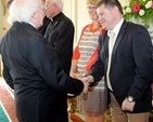 President Michael D Higgins welcomes Aonghus Dwane during the visit of Cumann Gaelach na hEaglaise to Áras and Uachtaráin. 