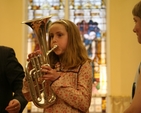 One of the young people present at the Sunday School Society's Concert tries her hand at the Euphonium. The concert marked 200 years of the society's existence.