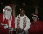 Pictured at the Multi-cultural Carol Service in St George and St Thomas's Church, Cathal Brugha Street, were special guest Santa Claus; the Revd Obinna Ulogwara, Rector; and Gillian Dean, Churchwarden. 