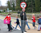 The rector of Powerscourt, Archdeacon Ricky Rountree, was on hand to help the children of Powerscourt NS cross the road on the final leg of their journey to their new school building. 