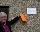 The Most Revd Dr John Neill, Archbishop of Dublin, unveils the plaque at the tree planting as part of the ecumenical service at Mount Seskin Community College, Tallaght.
