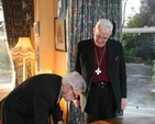 As the Archbishop of Dublin, the Most Revd Dr John Neill watches, the Ambassador of Belgium to Ireland, HE Robert Devriese signs the visitors book on his visit to the See House in Dublin.