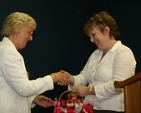 Niamh O'Mahony, Churchwarden of Greystones (right) presents a bouquet of flowers to Betty Neill at the institution of the Revd David Mungavin as Rector of Greystones.