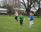 Student of the Church of Ireland College of Education playing Gaelic Football on the college green.