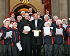 Archbishop Michael Jackson and Archbishop Diarmuid Martin with the choir of the Catholic University School at the Black Santa Sit Out at St Ann’s Church, Dawson Street, on Thursday December 20. An estimated €15,000 had been collected for charity in the first four days of the appeal which continues until Christmas Eve. 