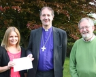 Pictured is ordinand Nicola Halford presenting a cheque to the Rt Revd Michael Burrows, Bishop of Cashel and Ossory for Bishops' Appeal, the proceeds of the ordinand's 'wax, shave, try or dye' fundraising effort. Also pictured is Martin O'Connor of Bishops' Appeal.