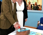 Past pupil of Powerscourt National School, Harry Williams, cuts the cake at the official opening of the new school. 