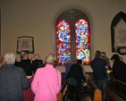 The congregation admire the new St Francis stained glass window in Sandford Parish Church. The window is in memory of the Threlfall family.