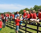 On the fence – some of the spectators at the West Glendalough Children’s Choral Festival observe the race at the sports day which took place in Dunlavin GAA on Friday June 7. 