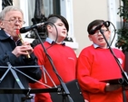 Paddy Moloney of the Chieftans plays at the Community Carol Singing outside the Mansion House on Saturday December 15 accompanying members of St Ultan’s School Choir. 
