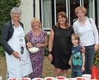 Margaret Wynne, Ann Maguire, Jenny Carty, Flora Simms and a young helper prepare for the Sandford and Milltown Parish Strawberries and Wine evening. 