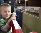 A young train enthusiast enjoying the exhibition.