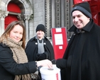 Another donation for the 'Black Santa' Haiti Earthquake Appeal received by the Curate of St Ann's, the Revd Victor Fitzpatrick. Also pictured (centre) is the Vicar of St Ann's, the Revd David Gillespie (aka Black Santa).