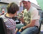 A young participant in Taney Parish Fete examines the Face Painting Work.