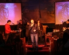 Greg Fromholz, Director of 3 Rock Youth speaking at Essential at Easter in Christ Church, Bray. In the background is the band Emmaus.