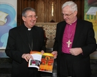The Most Revd Diarmuid Martin and the Most Revd Dr John Neill with the Gospel of Luke, jointly produced as an inititiave by the Roman Catholic Archdiocese of Dublin and the Church of Ireland United Dioceses of Dublin and Glendalough.