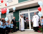 As Archbishop Michael Jackson cuts the ribbon at the official opening of the new building of Athy Model School, the pupils prepare to let go their balloons. 