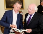Trevor Sargent shows his book to President Michael D Higgins during the visit of Cumann Gaelach na hEaglaise to Áras an Uachtaráin.