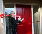 Elizabeth Rountree cuts the ribbon at the dedication of the new rectory at Powerscourt, Enniskerry. 