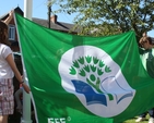 Pupils from Zion Parish School prepare the green flag to be hoisted at the ceremony. 